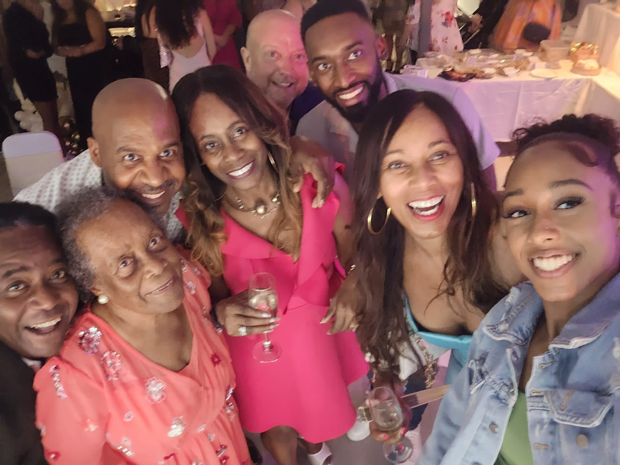 Angel Thomas celebrating with a group of clients